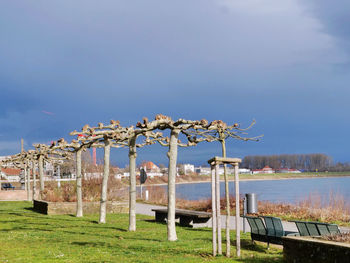 Built structure in park by lake against sky