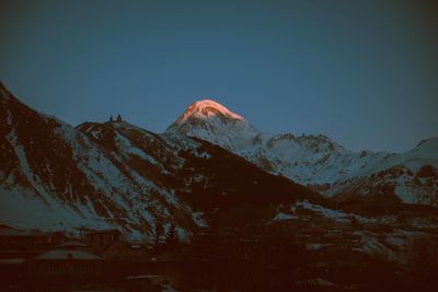 Scenic view of snowcapped mountains against clear sky