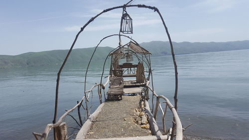 Lifeguard hut on beach against sky