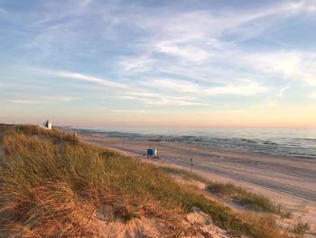 Scenic view of beach against sky during sunset