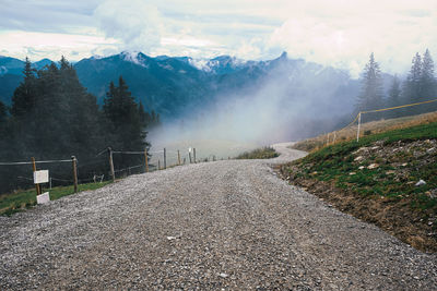 Footpath in the mountains through cloudy sky