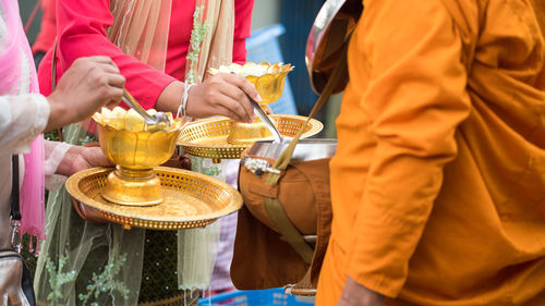 Midsection of man holding ice cream