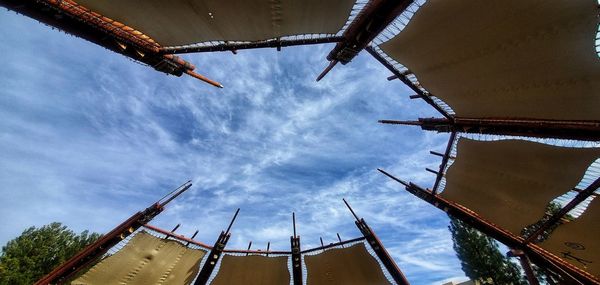 Low angle view of cranes against building