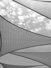 Low angle view of patterned tent roof against cloudy sky