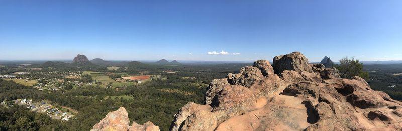 Panoramic view of landscape against clear blue sky