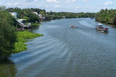 High angle view of river amidst trees against sky