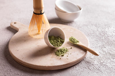 Powdered green tea matcha on a white stone board