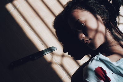 Close-up of thoughtful young woman by wall