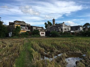 View of buildings against cloudy sky