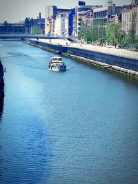 Boats in river with buildings in background