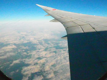 Aerial view of airplane wing over landscape