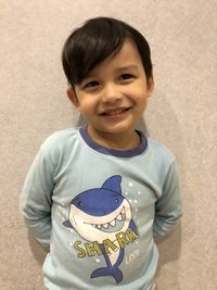 Portrait of smiling boy standing outdoors