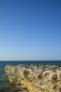 Scenic view of sea against clear blue sky