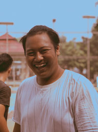 Portrait of smiling man standing outdoors