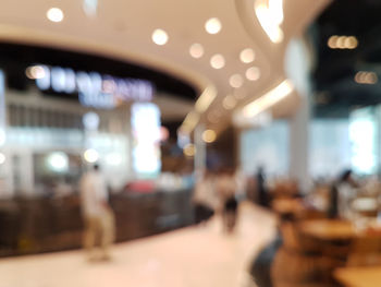 Defocused image of illuminated restaurant at night