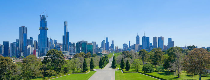 Panoramic view of trees and buildings against sky