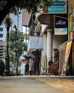 People walking on road against buildings