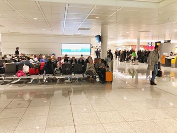 Group of people walking on tiled floor