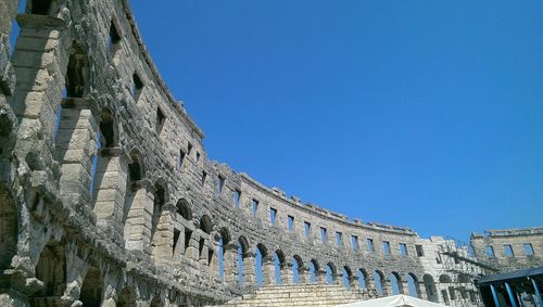 Low angle view of built structure against clear blue sky