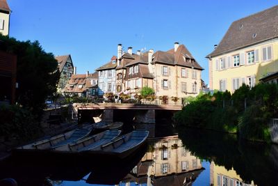 Canal amidst buildings against sky