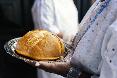 Woman holding bread on tray