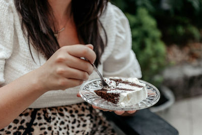 Close-up photo of woman eating cake