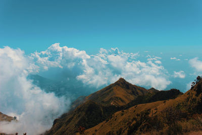 Panoramic view of majestic mountains against blue sky