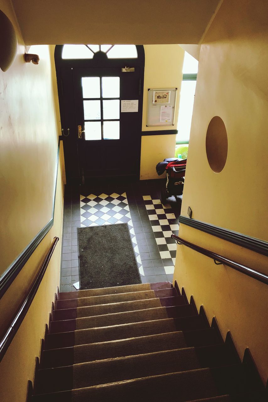 staircase, indoors, architecture, steps and staircases, railing, no people, direction, built structure, window, absence, day, the way forward, empty, high angle view, flooring, home interior, seat, illuminated, building, wall - building feature, luxury