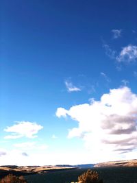 Scenic view of landscape against blue sky