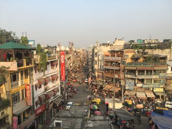 High angle view of vehicles on road amidst buildings in city