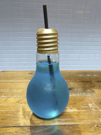 Close-up of glass bottle on table