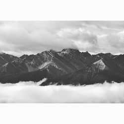 Scenic view of mountains against cloudy sky