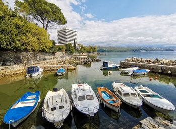 Boats moored in sea against sky