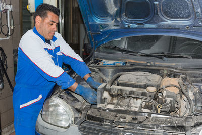 Mechanic repairing car