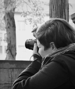 Close-up of woman photographing through dslr