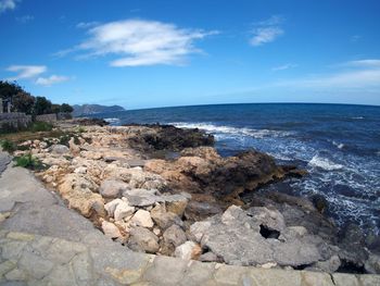 Scenic view of sea against cloudy sky