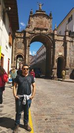 Full length portrait of man standing in front of san pedro church