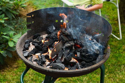 Close-up of firewood on barbecue grill in yard