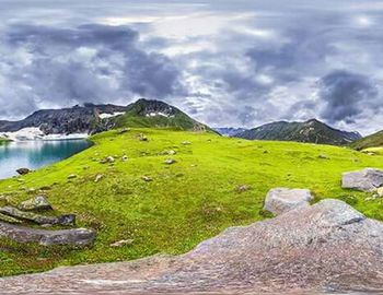 Scenic view of mountains against cloudy sky