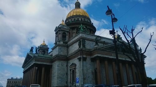 Low angle view of building against cloudy sky