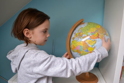 Girl watching a globe. globalization concept