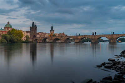 Prague in the evening with the charles bridge over the vltava.