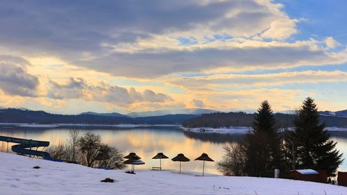 Scenic view of lake against sky during winter