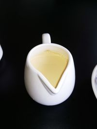 Close-up of tea cup against black background
