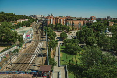 High angle view of railroad tracks amidst buildings in city