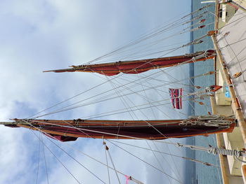 Low angle view of sailboat on sea against sky