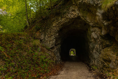 Rear view of woman standing in tunnel