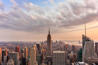 Empire state building at cityscape against sky