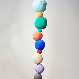 Stack of multi colored clay against gray background