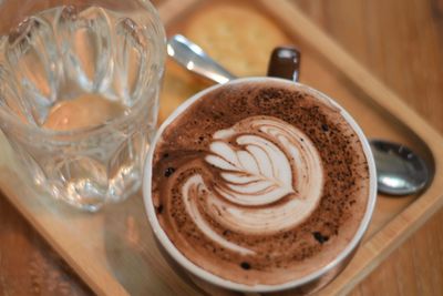 Close-up of cappuccino served on table